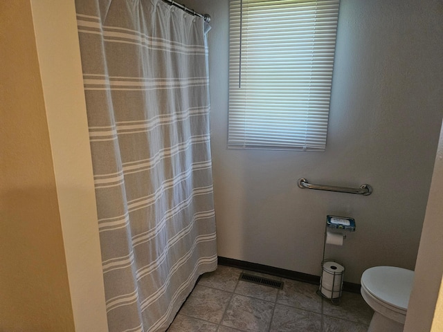 1427 Canary Dr, Albert Lea, MN 56007 - full bath with toilet, healthy amount of natural light, baseboards, and a shower with shower curtain