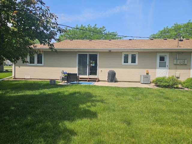 1427 Canary Dr, Albert Lea, MN 56007 - rear view of house with a patio, central AC, and a lawn