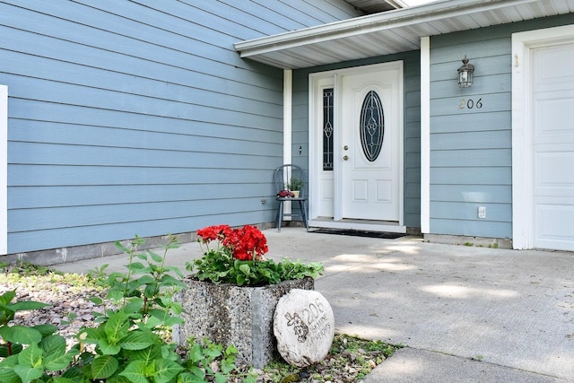 206 Skyline Hts, Wabasha, MN 55981 - view of exterior entry with an attached garage and a porch