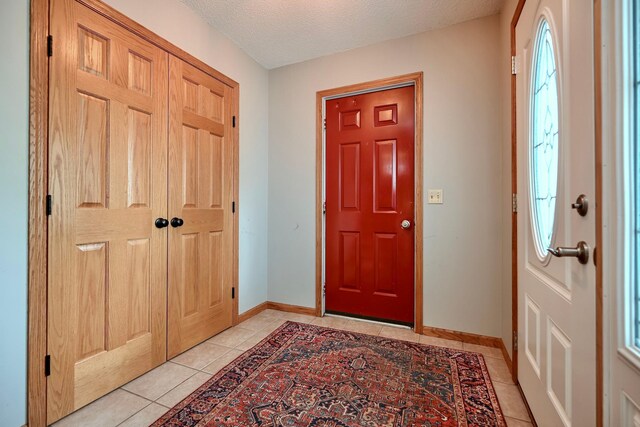 206 Skyline Hts, Wabasha, MN 55981 - entryway with light tile patterned flooring, baseboards, and a textured ceiling