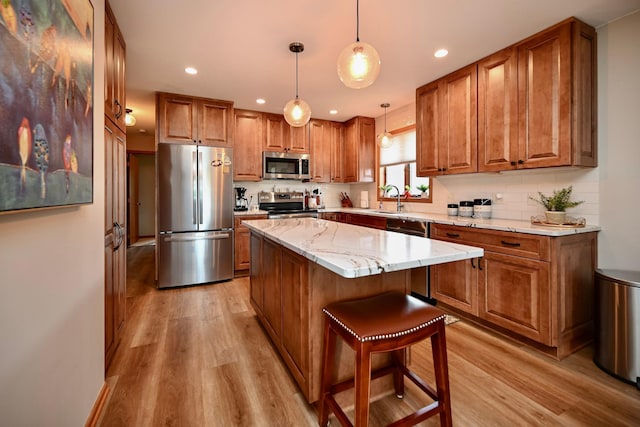 206 Skyline Hts, Wabasha, MN 55981 - kitchen featuring stainless steel appliances, brown cabinets, light wood-style flooring, recessed lighting, and backsplash