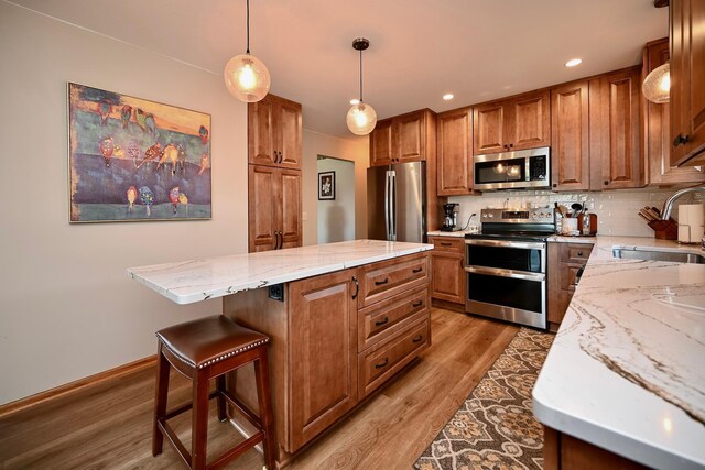 206 Skyline Hts, Wabasha, MN 55981 - kitchen featuring stainless steel appliances, a sink, brown cabinetry, and recessed lighting