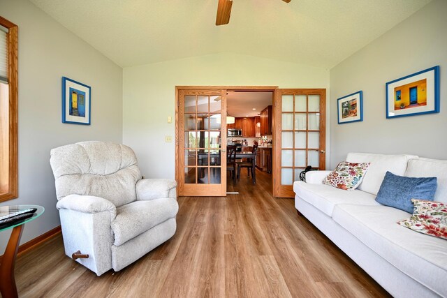 206 Skyline Hts, Wabasha, MN 55981 - living room with wood finished floors, vaulted ceiling, a ceiling fan, french doors, and baseboards
