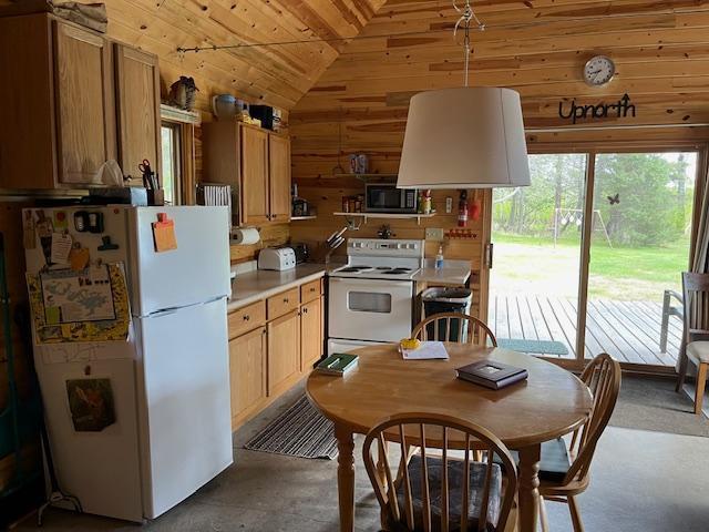 3573 Kallio Rd, Orr, MN 55771 - kitchen featuring white appliances, wooden ceiling, vaulted ceiling, wooden walls, and light countertops