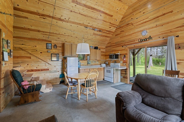 3573 Kallio Rd, Orr, MN 55771 - dining area featuring wooden walls, high vaulted ceiling, and concrete floors