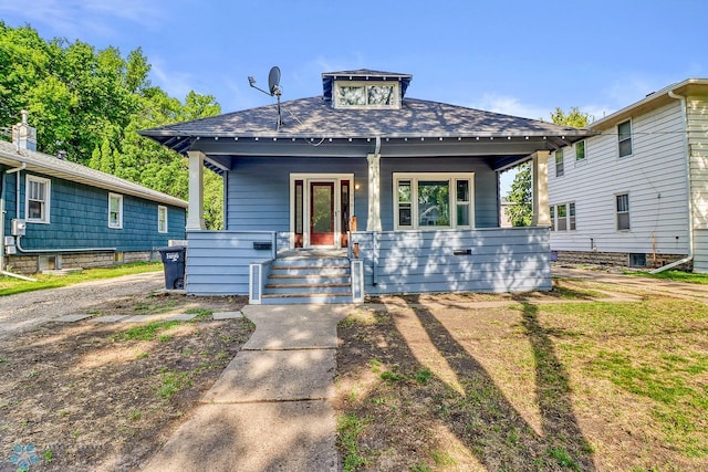 1036 12th St N, Fargo, ND 58102 - view of front of home featuring covered porch and a shingled roof