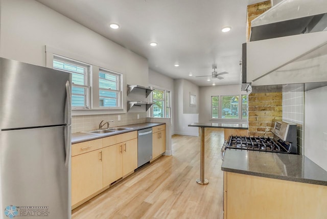1036 12th St N, Fargo, ND 58102 - kitchen with stainless steel appliances, light brown cabinets, recessed lighting, decorative backsplash, and ceiling fan