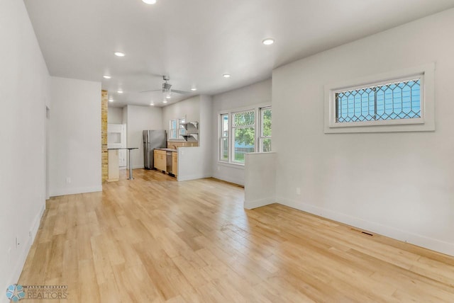 1036 12th St N, Fargo, ND 58102 - unfurnished living room with light wood finished floors, recessed lighting, baseboards, and ceiling fan
