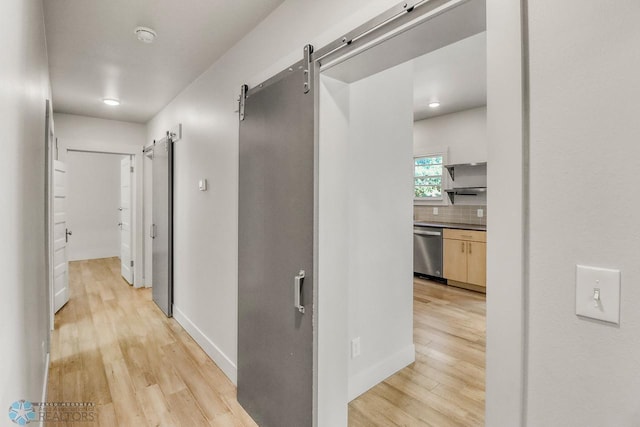 1036 12th St N, Fargo, ND 58102 - hall featuring a barn door, light wood-style flooring, and baseboards