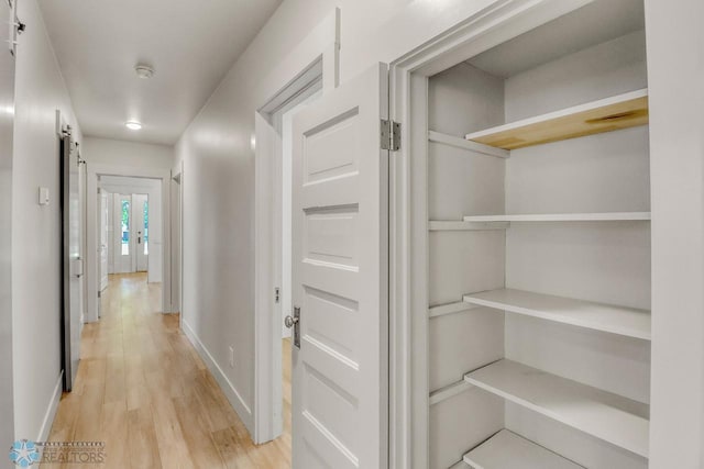 1036 12th St N, Fargo, ND 58102 - corridor featuring light wood-style floors, baseboards, and a barn door