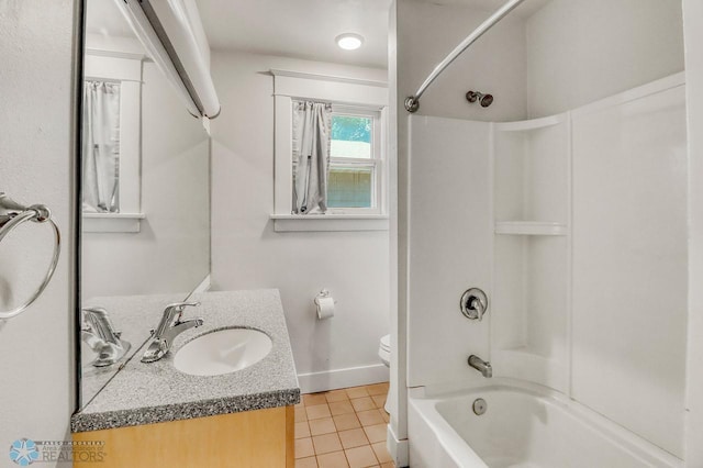1036 12th St N, Fargo, ND 58102 - full bath featuring tile patterned floors, vanity,  shower combination, toilet, and baseboards