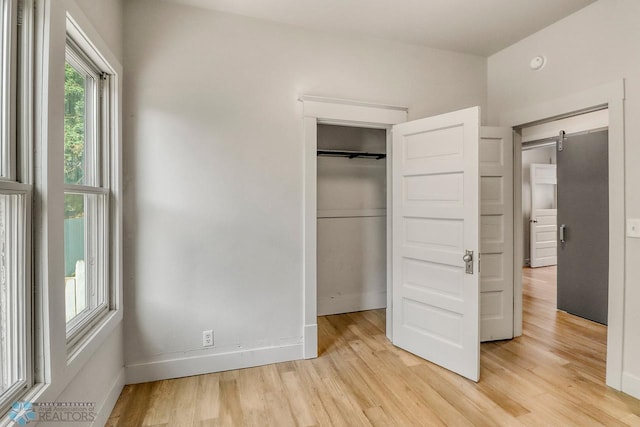 1036 12th St N, Fargo, ND 58102 - unfurnished bedroom featuring light wood finished floors, a closet, and baseboards