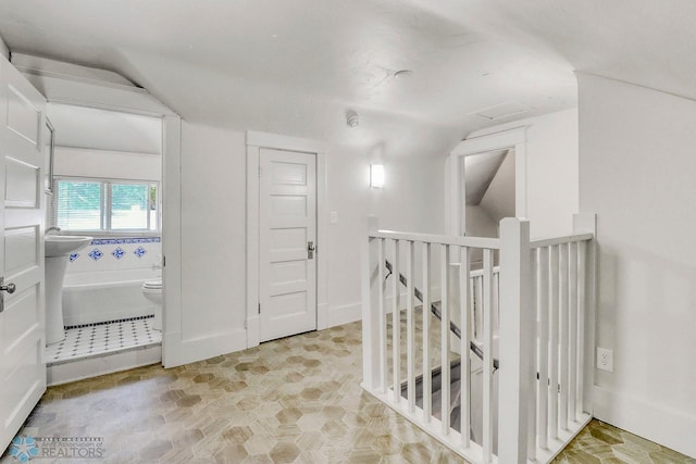 1036 12th St N, Fargo, ND 58102 - corridor with an upstairs landing and vaulted ceiling