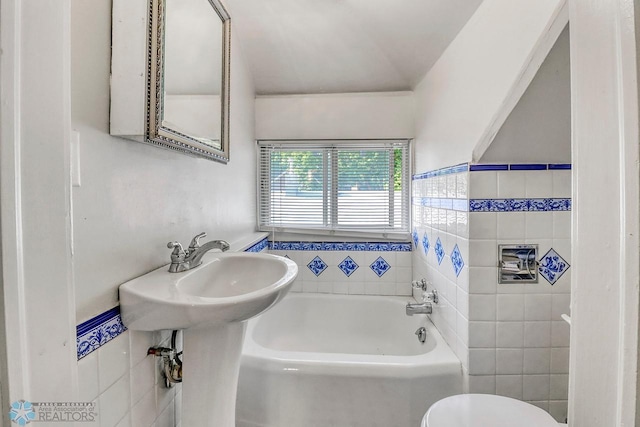 1036 12th St N, Fargo, ND 58102 - bathroom with a garden tub, tile walls, and toilet