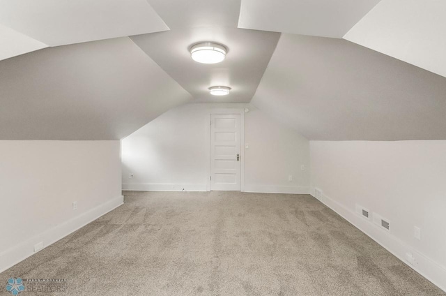 1036 12th St N, Fargo, ND 58102 - bonus room with lofted ceiling, carpet, and baseboards