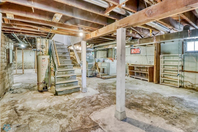 1036 12th St N, Fargo, ND 58102 - below grade area featuring gas water heater, independent washer and dryer, stairway, and a sink