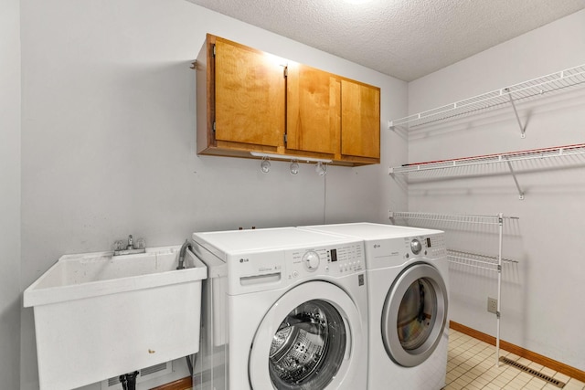 6260 Wessel Ct, Eden Prairie, MN 55346 - laundry room featuring cabinet space, washing machine and clothes dryer, baseboards, and a textured ceiling