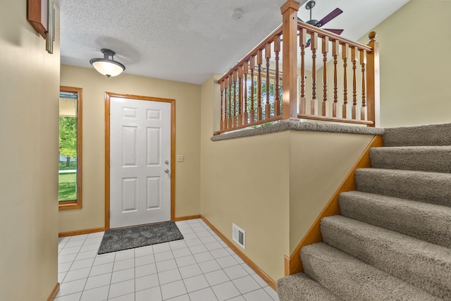 6260 Wessel Ct, Eden Prairie, MN 55346 - entrance foyer featuring stairway, light tile patterned floors, and a textured ceiling