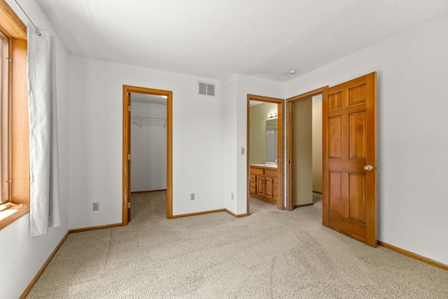 6260 Wessel Ct, Eden Prairie, MN 55346 - unfurnished bedroom featuring light colored carpet, a walk in closet, a closet, and ensuite bath