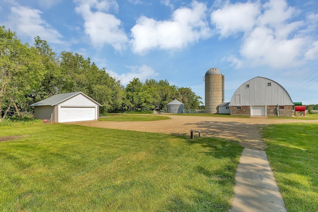 37454 605th Ave, Bluffton Twp, MN 56518 - view of grassy yard featuring a garage, an outdoor structure, and dirt driveway