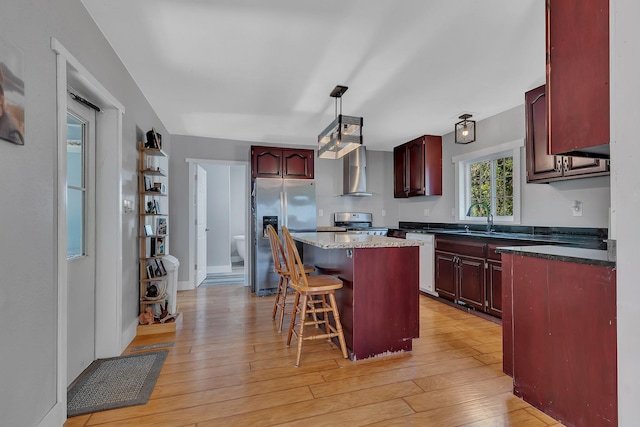 37454 605th Ave, Bluffton Twp, MN 56518 - kitchen with appliances with stainless steel finishes, reddish brown cabinets, wall chimney range hood, and a center island