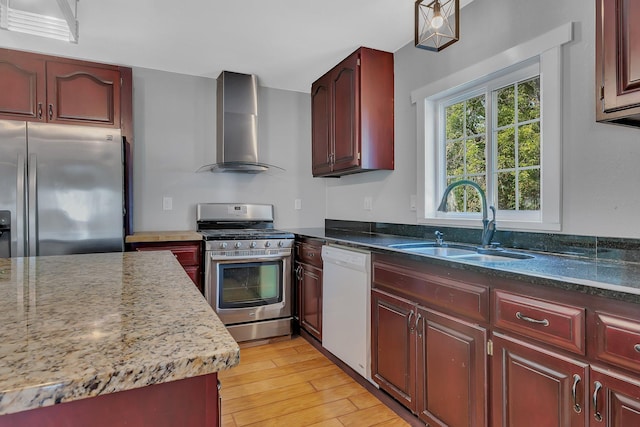 37454 605th Ave, Bluffton Twp, MN 56518 - kitchen with stainless steel appliances, wall chimney range hood, reddish brown cabinets, a sink, and light wood-style flooring