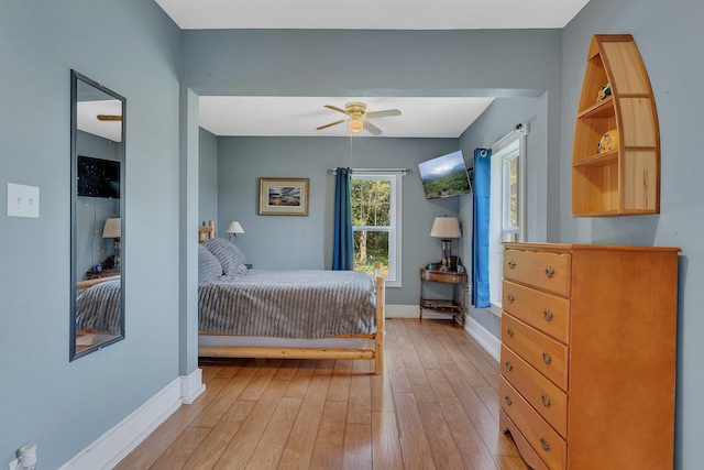 37454 605th Ave, Bluffton Twp, MN 56518 - bedroom featuring baseboards, light wood-type flooring, and a ceiling fan