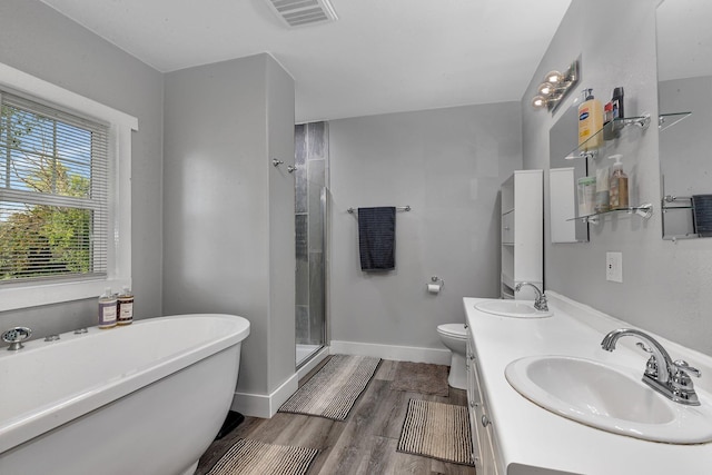 37454 605th Ave, Bluffton Twp, MN 56518 - bathroom with a soaking tub, a shower stall, double vanity, wood finished floors, and baseboards