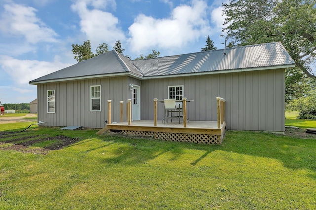 37454 605th Ave, Bluffton Twp, MN 56518 - back of house with a wooden deck, metal roof, a yard, and board and batten siding