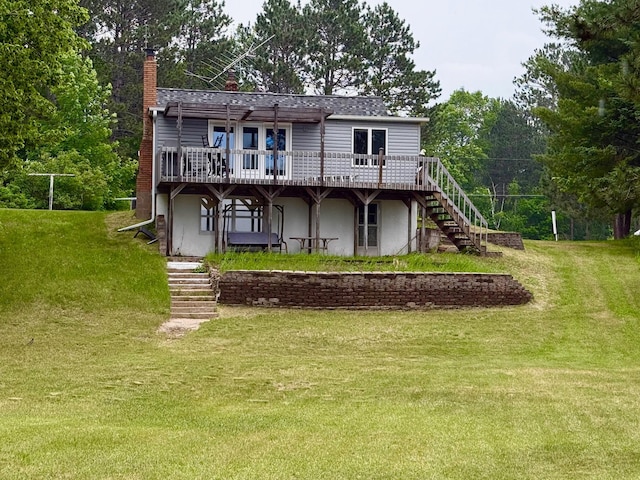 30055 Shore Dr, Pengilly, MN 55775 - back of house with stairs, a wooden deck, a chimney, a lawn, and stucco siding