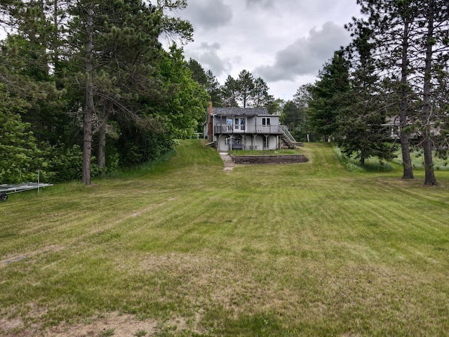 30055 Shore Dr, Pengilly, MN 55775 - view of grassy yard with stairs and a deck