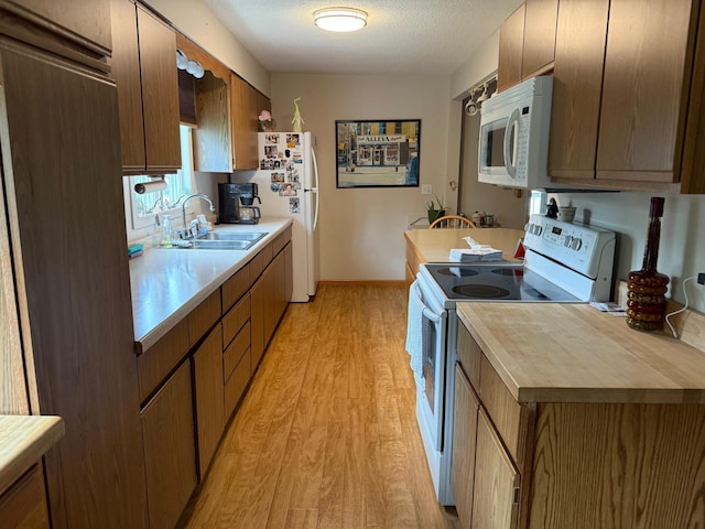 30055 Shore Dr, Pengilly, MN 55775 - kitchen with white appliances, light wood finished floors, and wooden counters