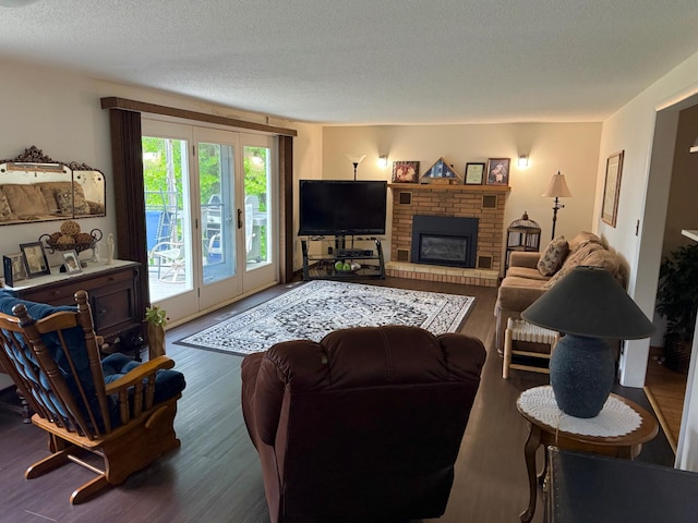 30055 Shore Dr, Pengilly, MN 55775 - living room with a textured ceiling, wood finished floors, and a brick fireplace