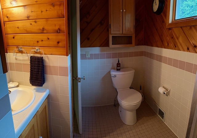 30055 Shore Dr, Pengilly, MN 55775 - bathroom with tile walls, vanity, and tile patterned flooring