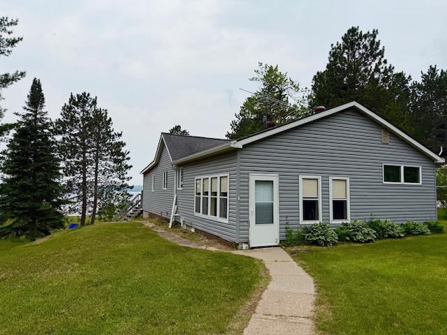 30055 Shore Dr, Pengilly, MN 55775 - view of front of property with a front yard and a shingled roof