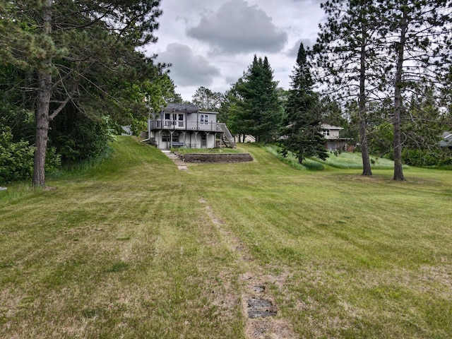 30055 Shore Dr, Pengilly, MN 55775 - view of green lawn with stairs and a wooden deck
