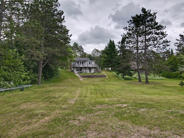 30055 Shore Dr, Pengilly, MN 55775 - view of grassy yard featuring stairs and a deck