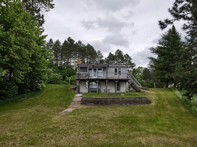 30055 Shore Dr, Pengilly, MN 55775 - rear view of property featuring stairway, a deck, a chimney, and a lawn