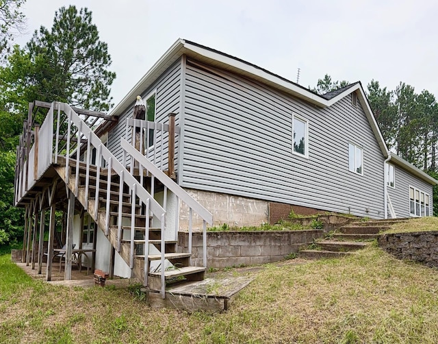 30055 Shore Dr, Pengilly, MN 55775 - view of property exterior with stairway, a patio, a wooden deck, and a yard