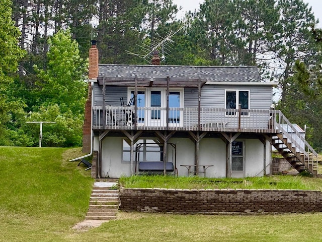 30055 Shore Dr, Pengilly, MN 55775 - rear view of property featuring stairway, a wooden deck, a lawn, and a chimney