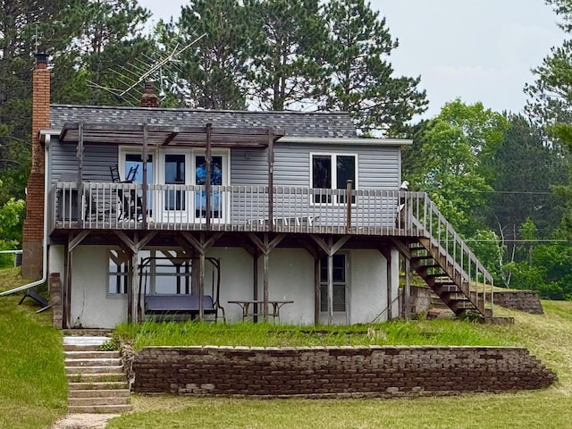 30055 Shore Dr, Pengilly, MN 55775 - rear view of house featuring stairway, a chimney, a wooden deck, and stucco siding