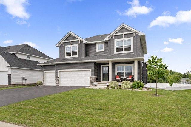 5945 178th St W, Lakeville, MN 55044 - craftsman-style home featuring asphalt driveway, a porch, a garage, stone siding, and board and batten siding