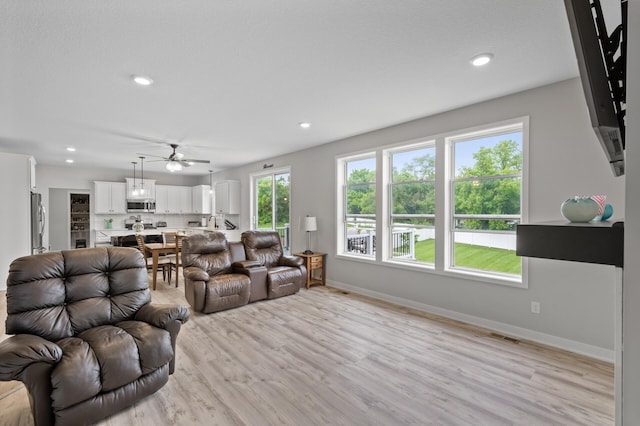 5945 178th St W, Lakeville, MN 55044 - living room featuring light wood-type flooring, ceiling fan, baseboards, and recessed lighting