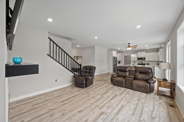 5945 178th St W, Lakeville, MN 55044 - living room with ceiling fan, light wood-type flooring, stairs, recessed lighting, and baseboards