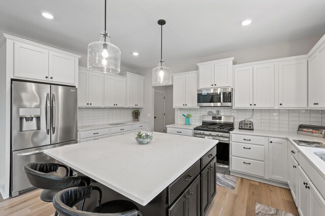 5945 178th St W, Lakeville, MN 55044 - kitchen featuring appliances with stainless steel finishes, white cabinetry, light countertops, and recessed lighting