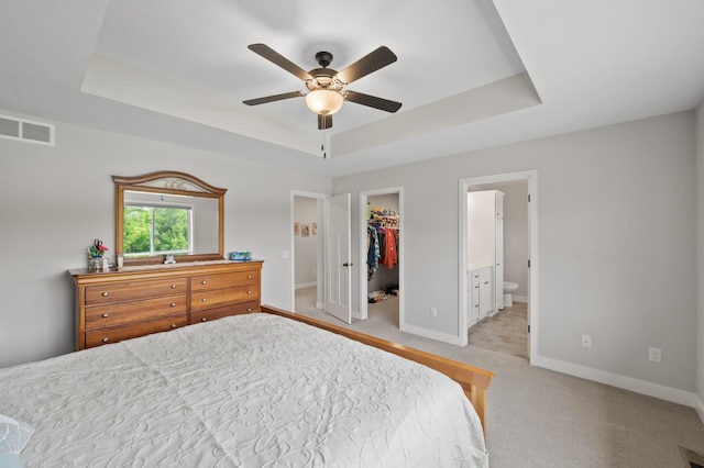 5945 178th St W, Lakeville, MN 55044 - bedroom with a tray ceiling, a walk in closet, baseboards, light carpet, and a closet
