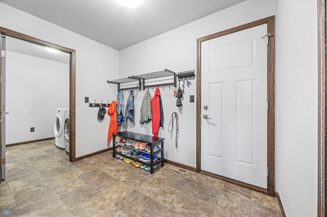 2200 39th St S, Moorhead, MN 56560 - washroom featuring separate washer and dryer, stone finish flooring, and baseboards