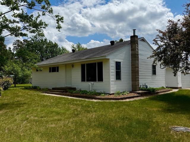 604 10th Ave, Grand Rapids, MN 55744 - view of side of home with a chimney and a lawn