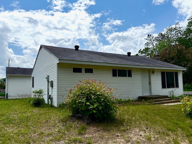 604 10th Ave, Grand Rapids, MN 55744 - back of house featuring a chimney