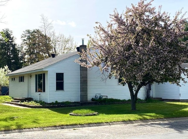 604 10th Ave, Grand Rapids, MN 55744 - view of property exterior with a chimney and a yard